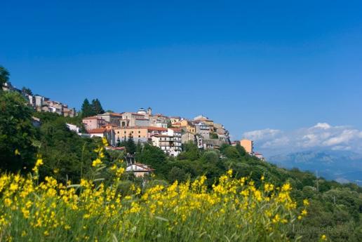 Panorama of the historic village with stone houses and mountain views.