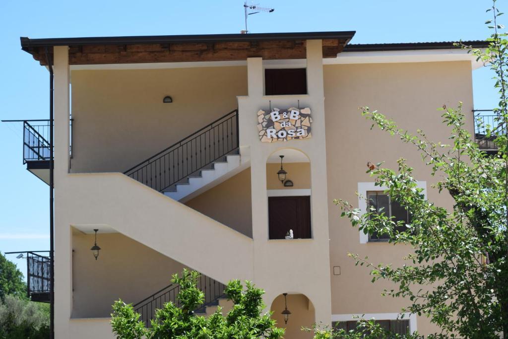 B&B da Rosa: accommodation with beige facade, external stairs and balconies.