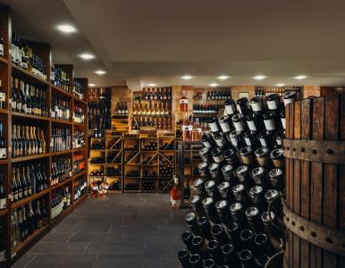 Cave à vin avec des étagères de vins, de champagne et de bouteilles de grands crus.
