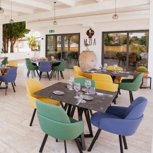 Elegant and contemporary outdoor dining area with colorful tables and chairs.